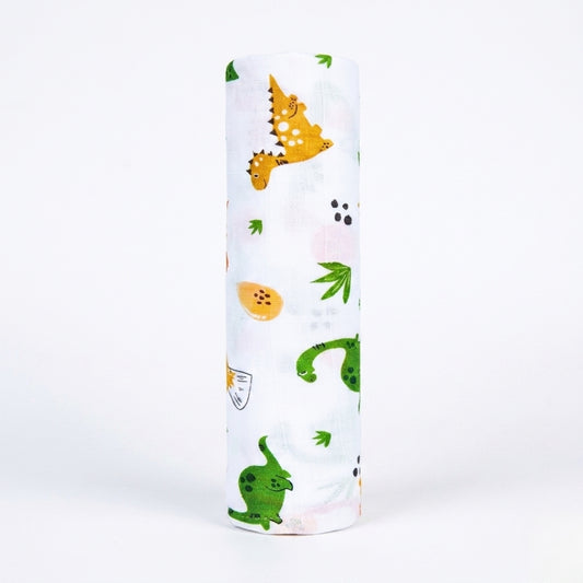 White cylindrical swaddle with colourful dinosaur illustrations on a white background