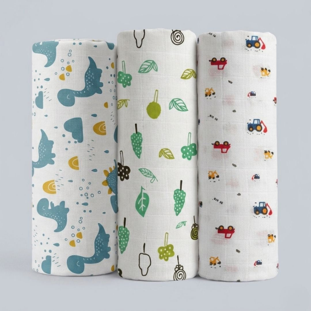 LazyToddler baby swaddle wrap set of 3 in Blue Dino, Leaf and Crane prints laid flat