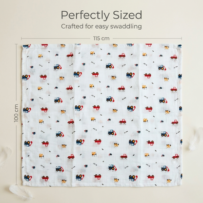 Newborn wrapped in soft Crane print muslin swaddle blanket by LazyToddler