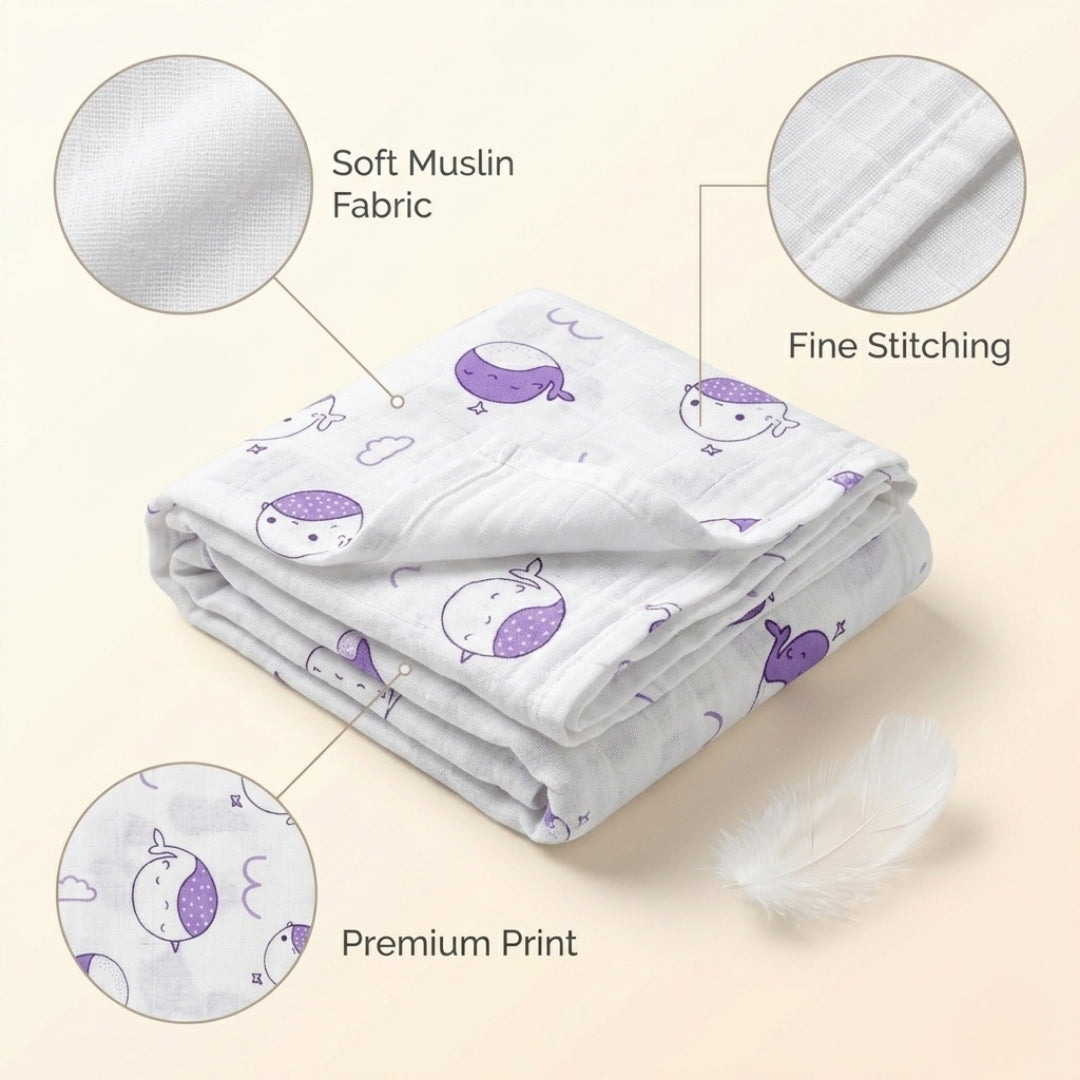 Newborn baby wrapped in soft organic muslin swaddle blanket with animal design