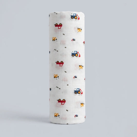 Folded crane swaddle muslin fabric with vehicle pattern on a light gray background