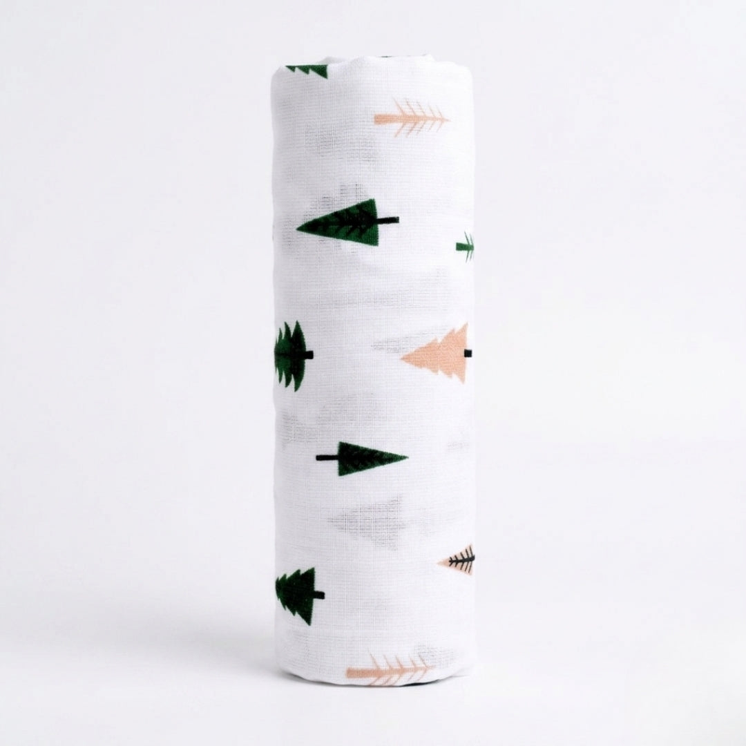 White swaddle blanket with green and pink arrow patterns on a white background