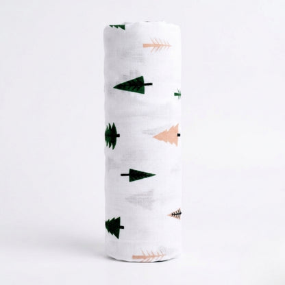 White swaddle blanket with green and pink arrow patterns on a white background